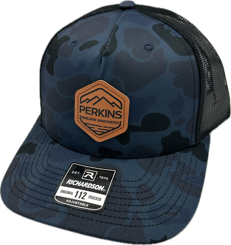 Genuine Leather Patch - Richardson 112PFP Snapback Trucker Hat - Admiral Duck Camo/Black - Perkins Builder Brothers